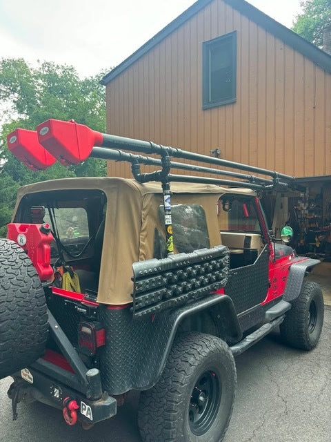 Customer's SUV with carrier, camped by a river