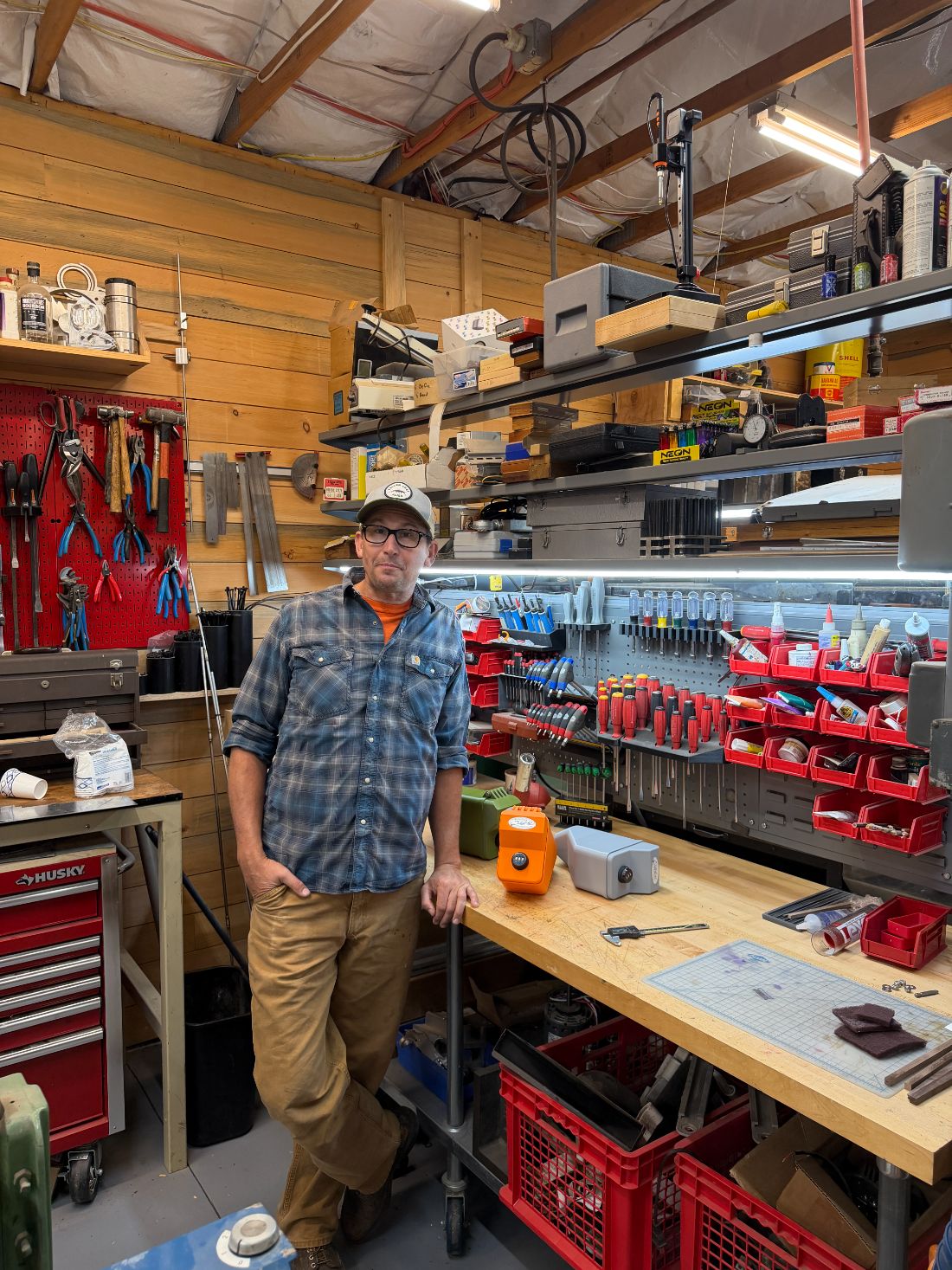 Ben Mitchell in his workshop next to finished reel boxes