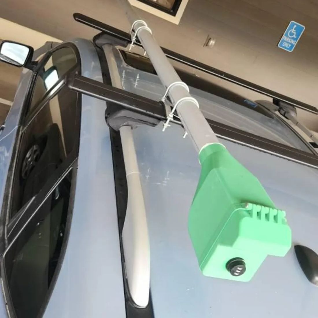Green locking reel box on a customer's car rack