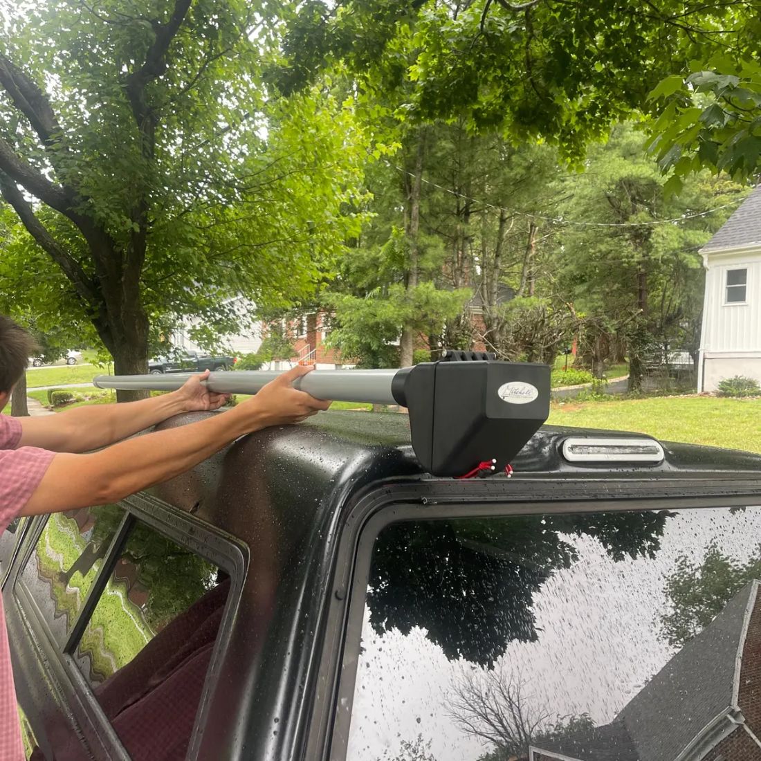 Customer fitting the carrier onto a truck cap