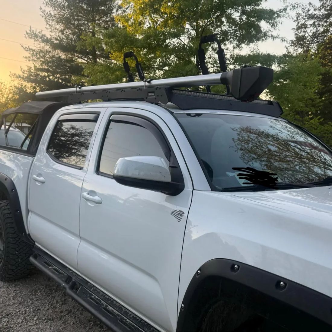 Customer's carrier mounted on a white pickup roof rack